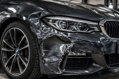 Car front wing and bumper with collision damage before repair