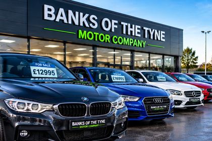Used cars with price cards lined up outside the Banks of the Tyne showroom