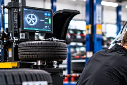 Wheel alignment equipment fitted to a car on a ramp